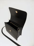 Maison Arlen Legacy Bag Black Edition open top view showing interior compartments with gold accents on white background