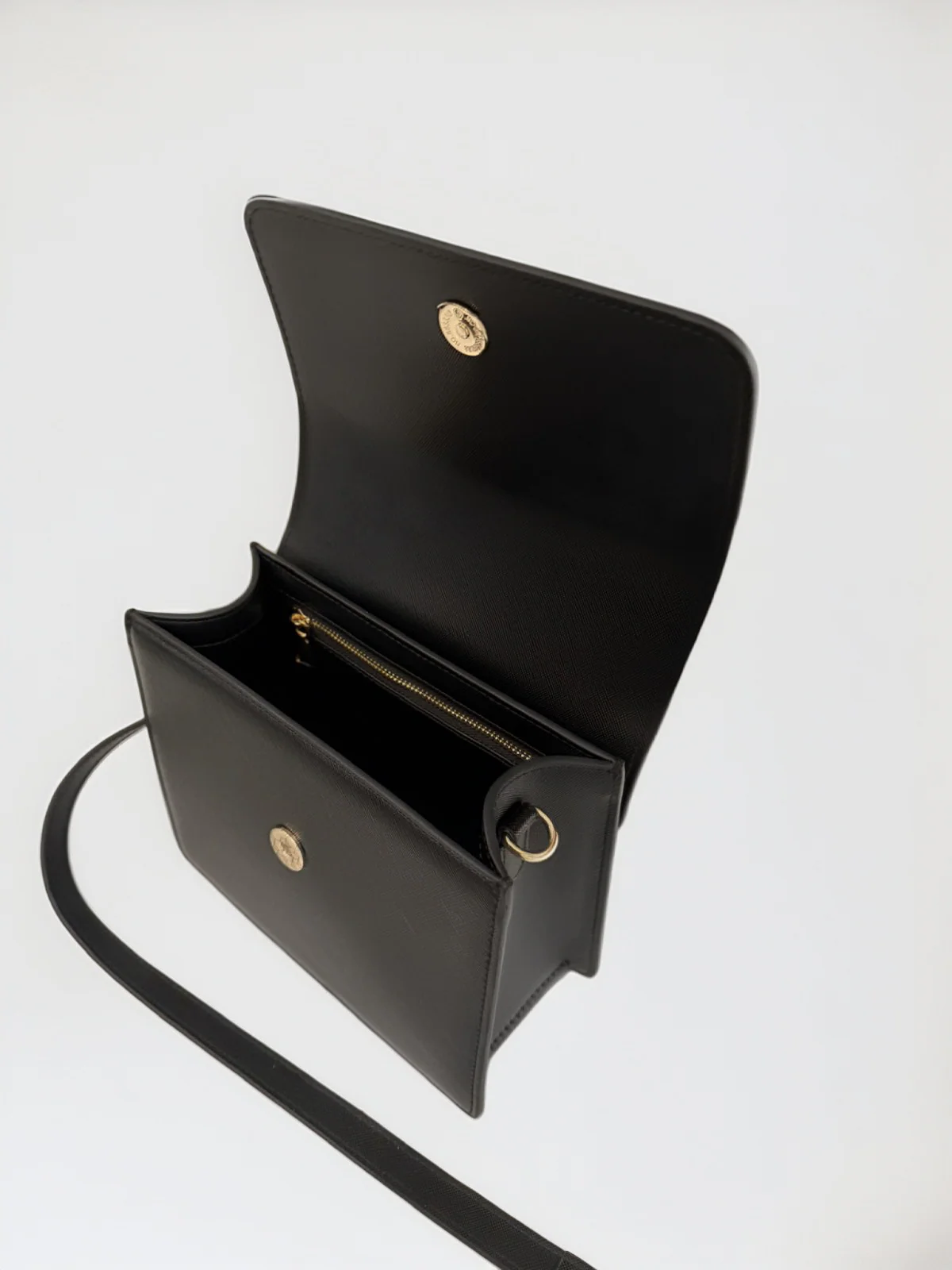 Maison Arlen Legacy Bag Black Edition open top view showing interior compartments with gold accents on white background