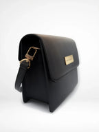 Maison Arlen Legacy Bag Black Edition side view with gold buckle and gold logo plaque on white background